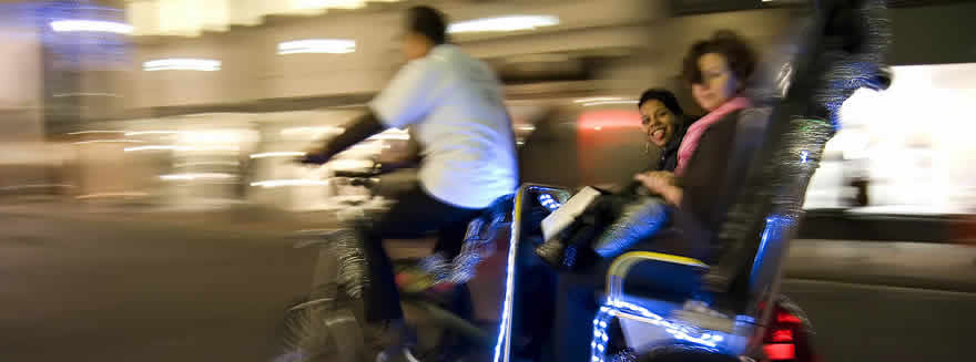 Two female passengers enjoying the journey on a Bugbugs pedicab