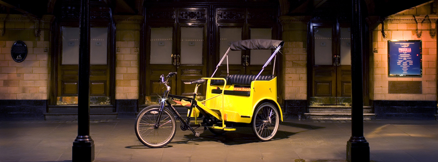 A Bugbugs rickshaw under the spotlight, outside a west end theatre at night